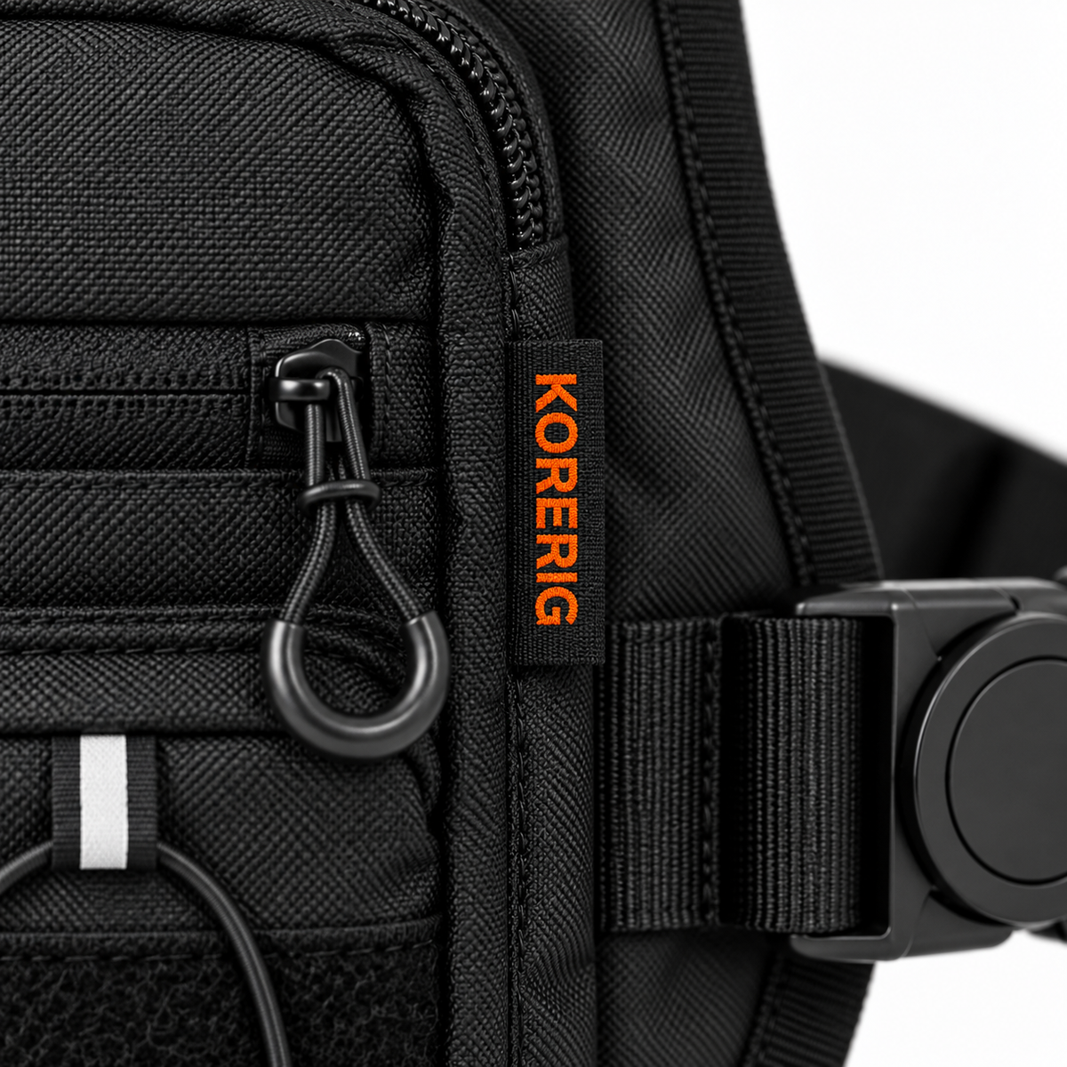 Black woven side label with orange KORERIG lettering